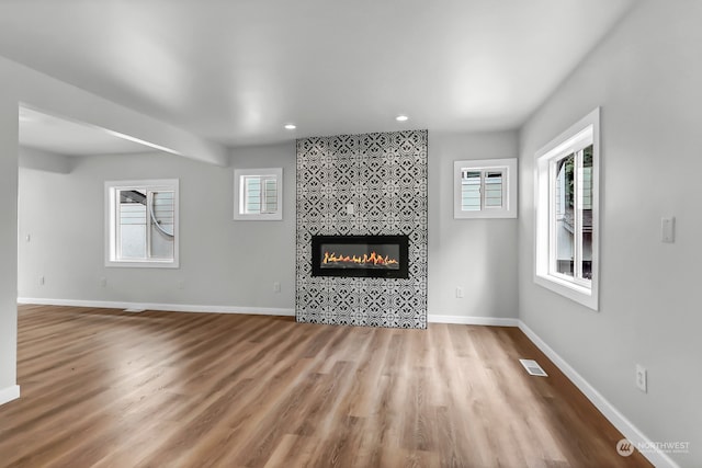 unfurnished living room with plenty of natural light and wood-type flooring