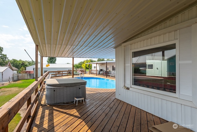 deck with a pool with hot tub