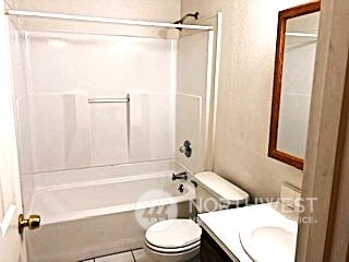 full bathroom featuring  shower combination, vanity, toilet, and tile patterned floors