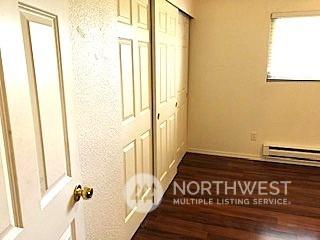 12602 NE 118th St, Kirkland, WA 98034 - unfurnished bedroom with a closet and a baseboard heating unit