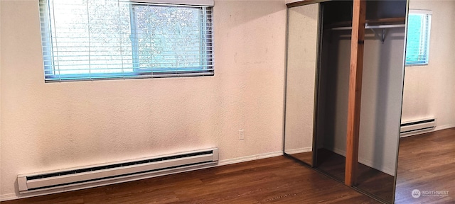 unfurnished bedroom featuring dark hardwood / wood-style floors, a closet, and a baseboard radiator