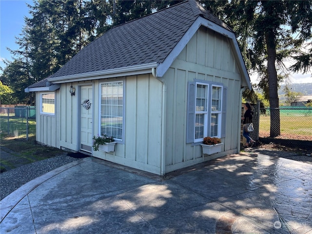 view of outbuilding with fence and an outdoor structure