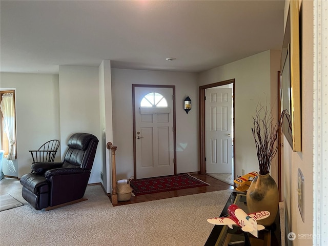 foyer with carpet and baseboards