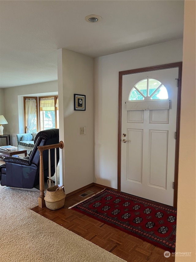 foyer with parquet flooring and plenty of natural light