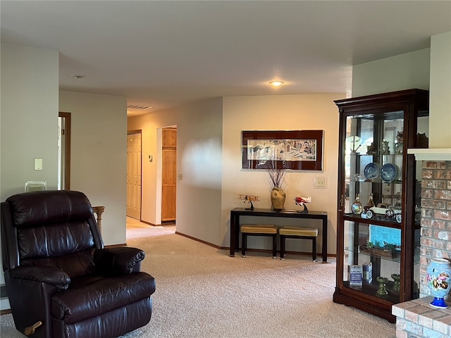 living area featuring light carpet