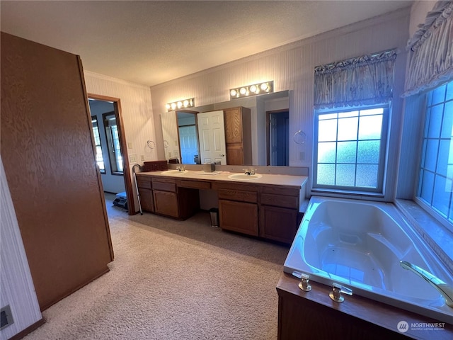 bathroom with double vanity, a bath, ornamental molding, and a sink