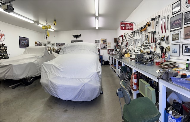 garage featuring a garage door opener and a workshop area