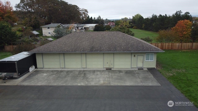 detached garage featuring fence