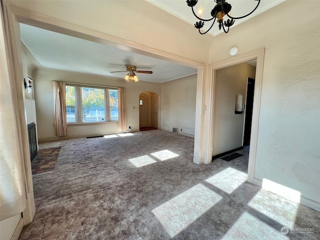 unfurnished living room featuring carpet floors and ceiling fan with notable chandelier