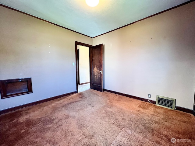 carpeted empty room with crown molding