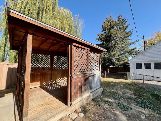 wooden terrace featuring an outdoor structure