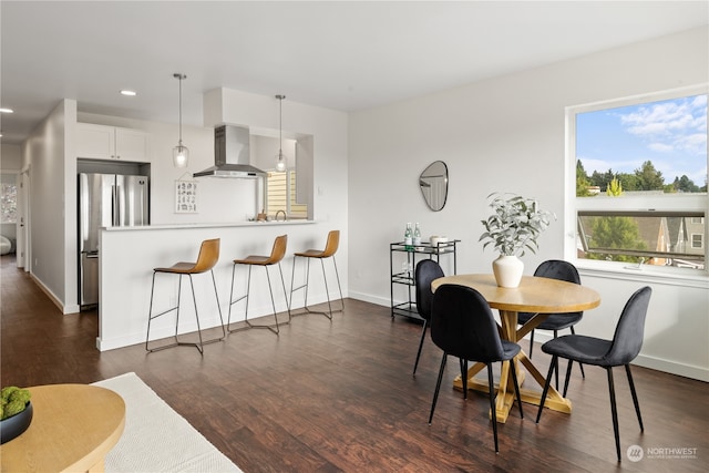 dining space with dark hardwood / wood-style flooring