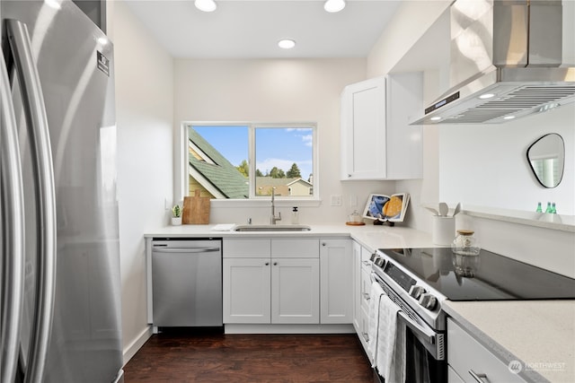 kitchen with stainless steel appliances, sink, dark wood-type flooring, wall chimney exhaust hood, and white cabinets