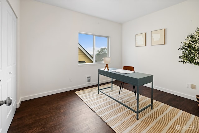 home office with dark hardwood / wood-style flooring