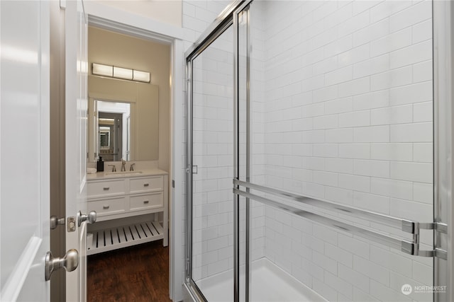 bathroom featuring vanity, hardwood / wood-style floors, and an enclosed shower