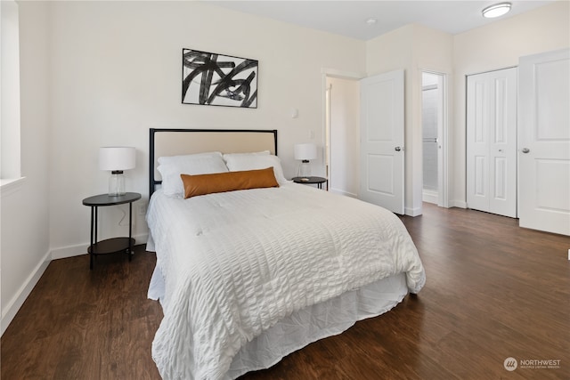 bedroom with a closet and dark hardwood / wood-style floors