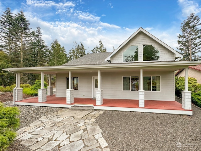 rear view of property with covered porch