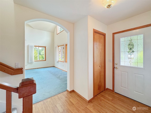 entryway featuring light colored carpet