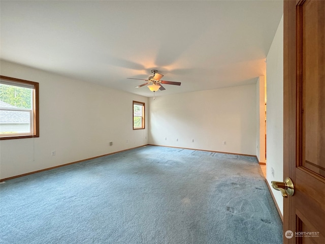 empty room with ceiling fan and carpet flooring