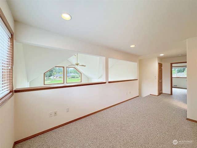 unfurnished room featuring carpet, lofted ceiling, and ceiling fan