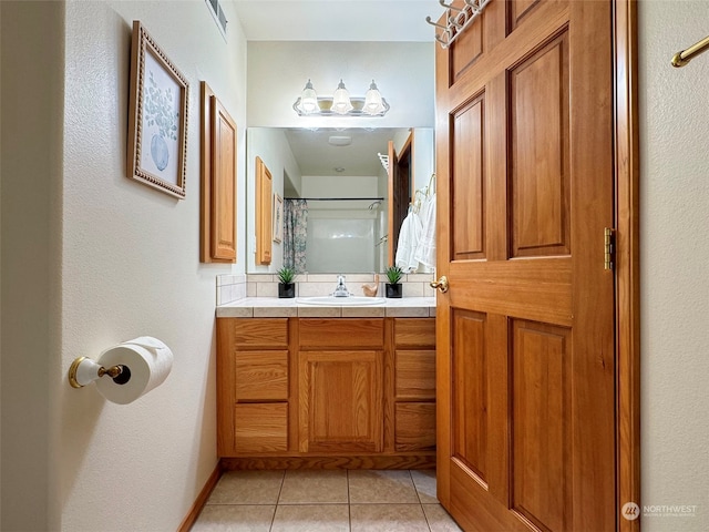 bathroom featuring a shower with shower curtain, tile patterned floors, and vanity