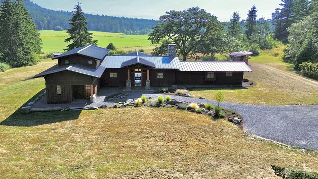 view of front facade with a front lawn and a rural view