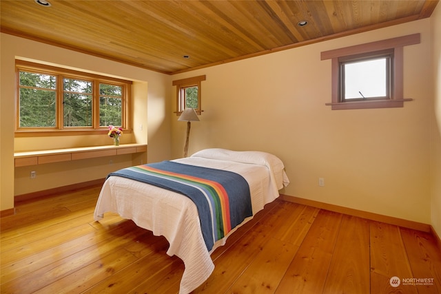 bedroom featuring wooden ceiling, crown molding, and wood-type flooring