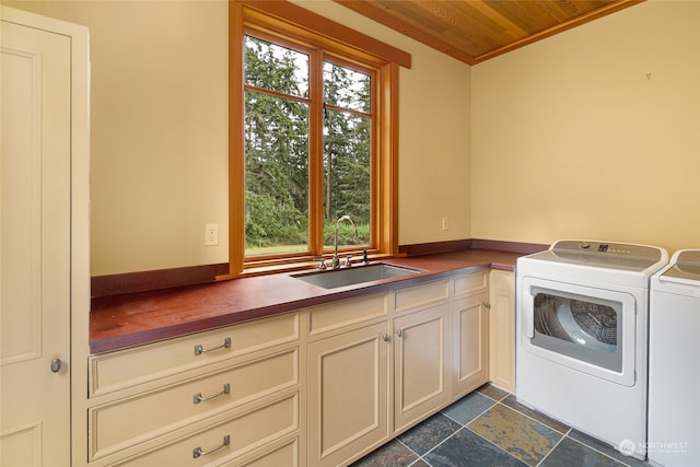 clothes washing area featuring cabinets, independent washer and dryer, and sink