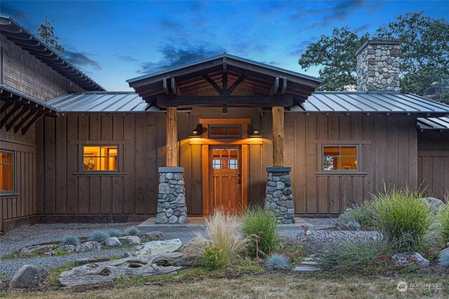 view of exterior entry at dusk