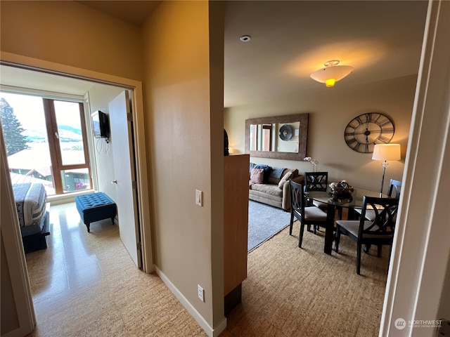 hallway featuring light carpet