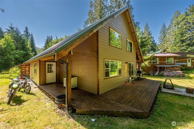 back of house featuring a yard and a deck