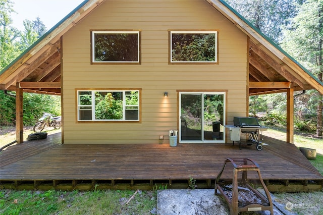 rear view of property featuring a wooden deck