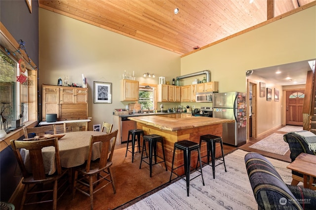 dining area featuring light carpet, high vaulted ceiling, and wooden ceiling