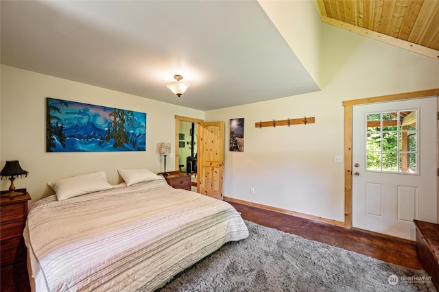 bedroom featuring vaulted ceiling, carpet, and wood ceiling