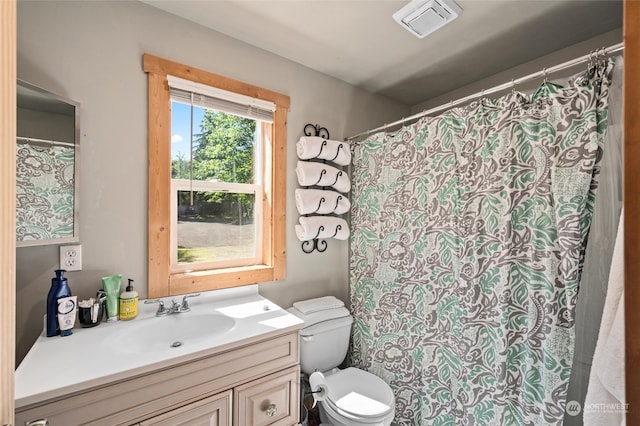 bathroom featuring toilet and vanity