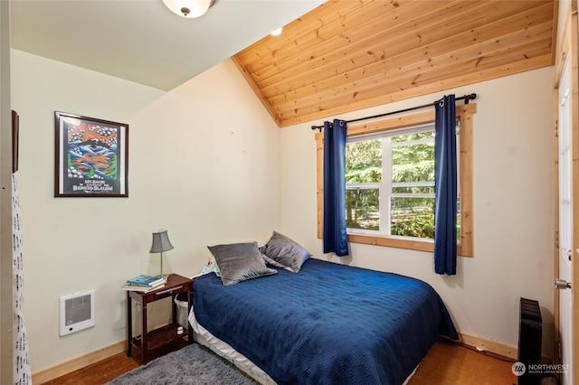 bedroom featuring hardwood / wood-style flooring, wood ceiling, and lofted ceiling