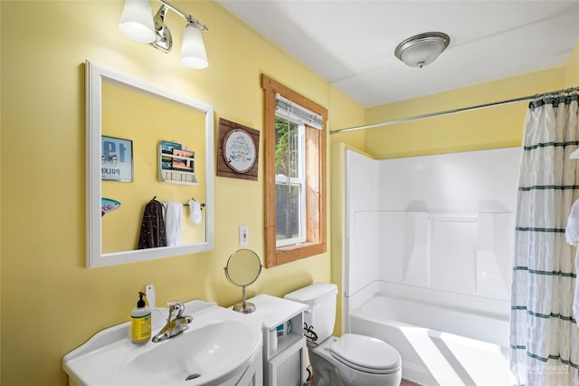 full bathroom featuring vanity, shower / bath combo, and toilet