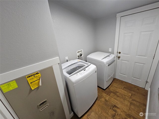 laundry room with dark hardwood / wood-style flooring and washing machine and dryer