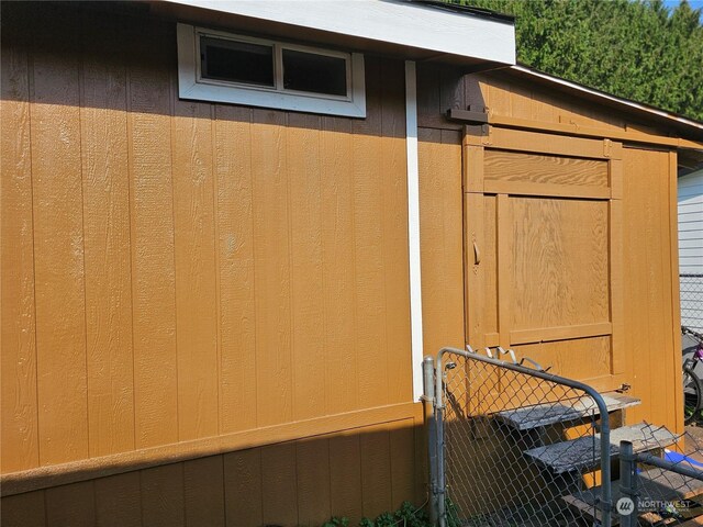 view of side of home with a shed