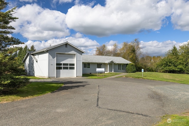 single story home with a front lawn and a garage