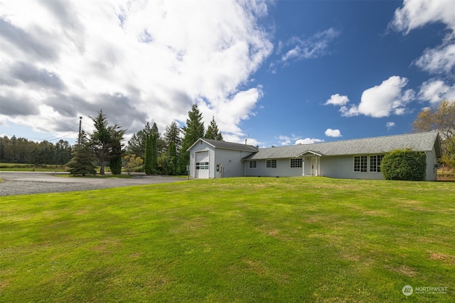 ranch-style home featuring a garage and a front yard