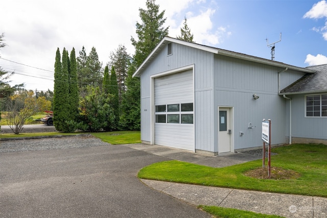 garage featuring a lawn