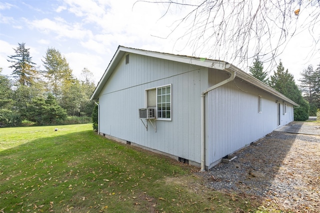 view of side of home with a lawn