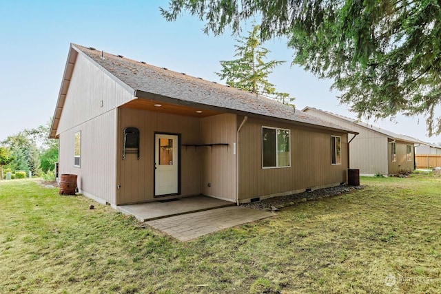 rear view of property with a patio and a yard