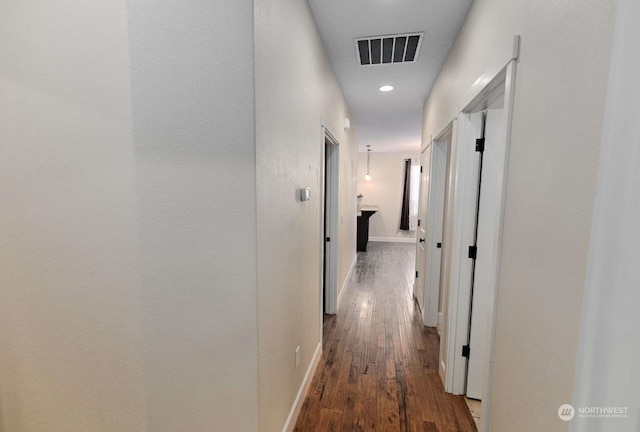 hallway with dark hardwood / wood-style flooring