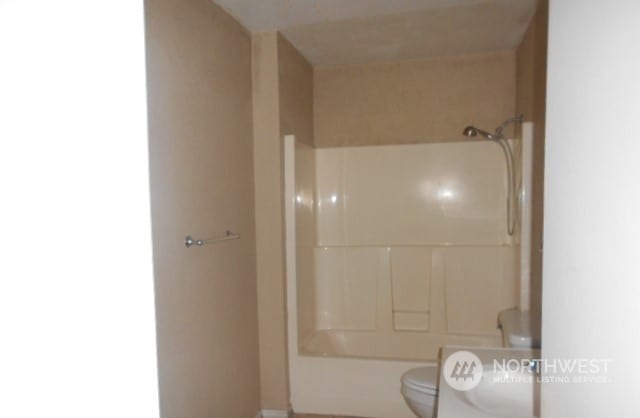 bathroom with shower / bathtub combination and toilet