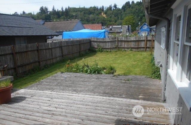 wooden deck featuring a yard