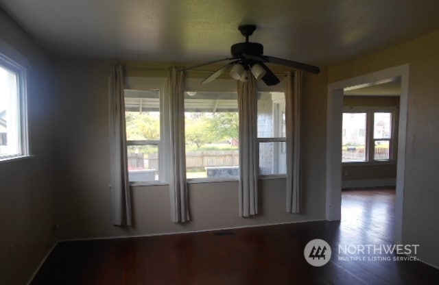 spare room with a healthy amount of sunlight and ceiling fan