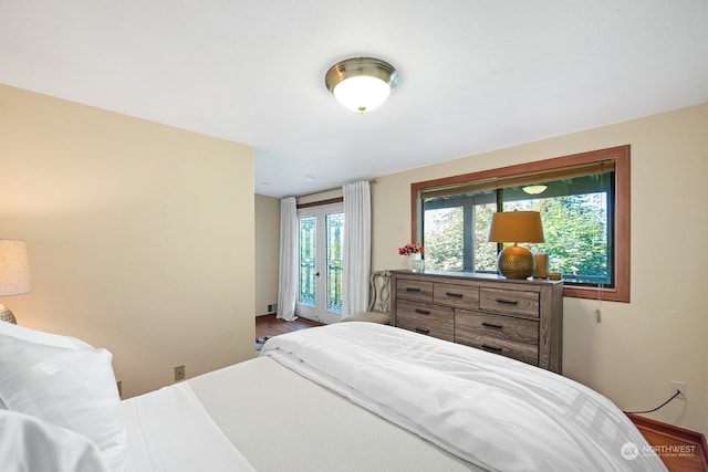 bedroom featuring hardwood / wood-style flooring and access to outside