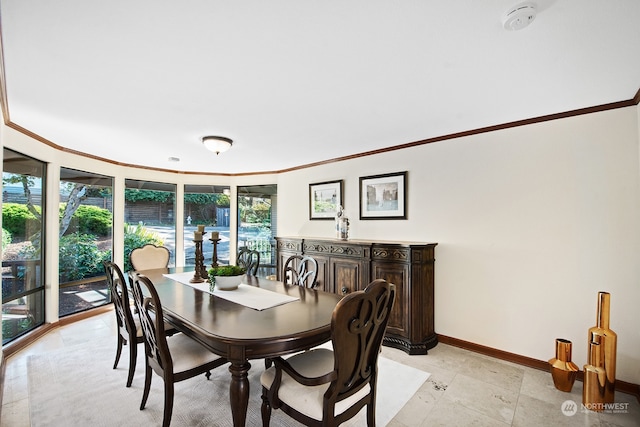 dining area with crown molding and plenty of natural light